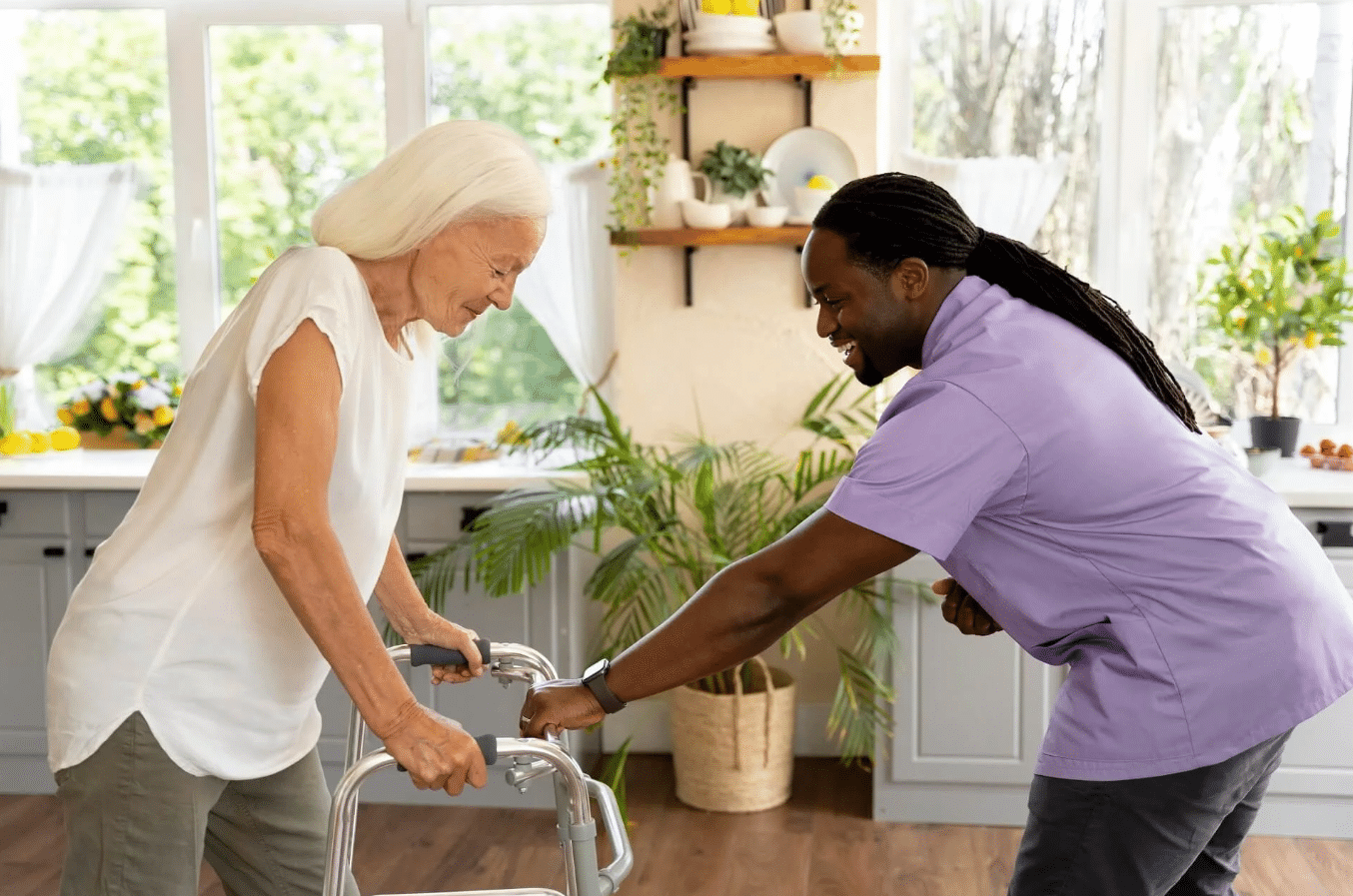 Black caregiver speaking with an older adult in a bright home